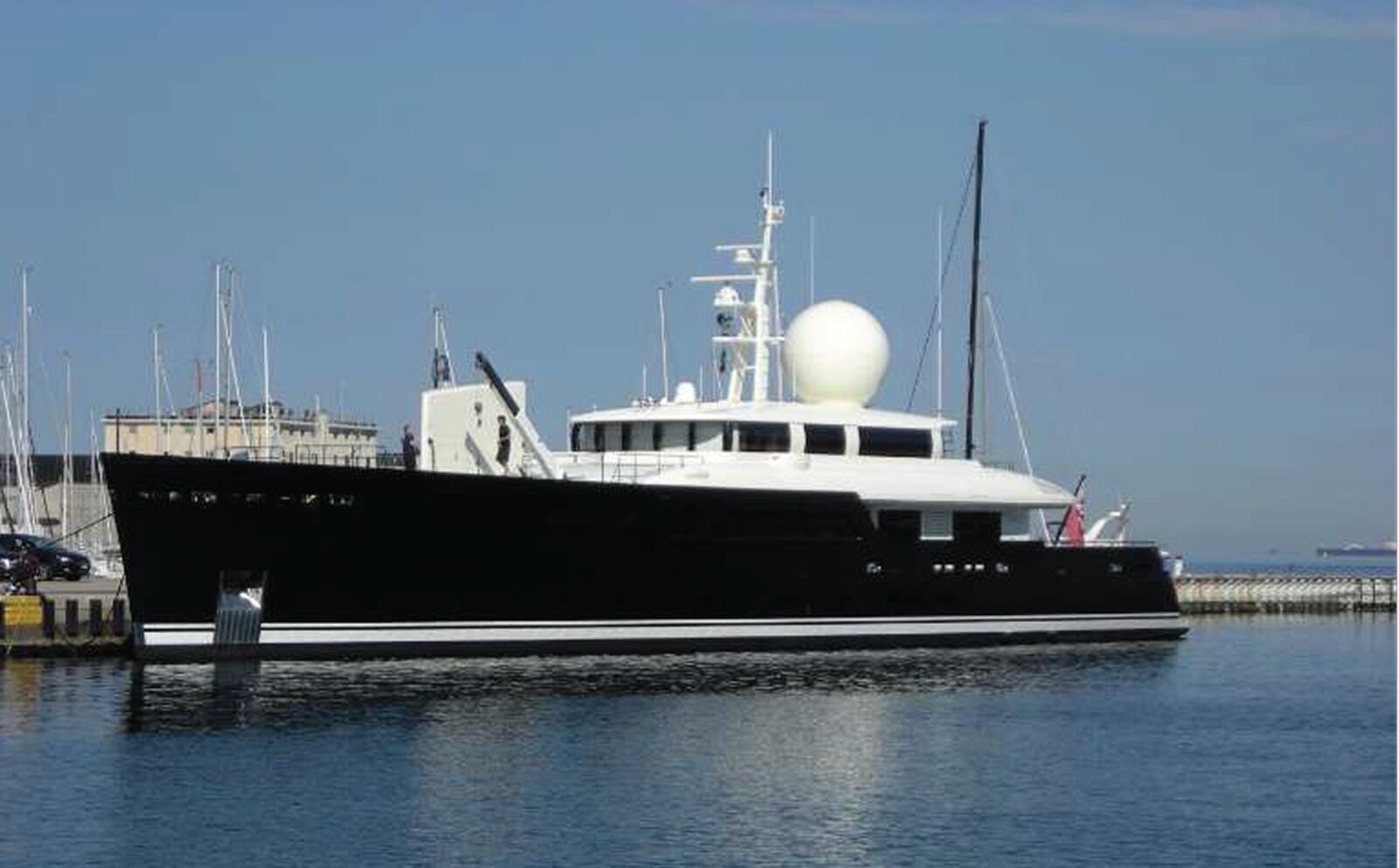 A large motor yacht moored at a marina