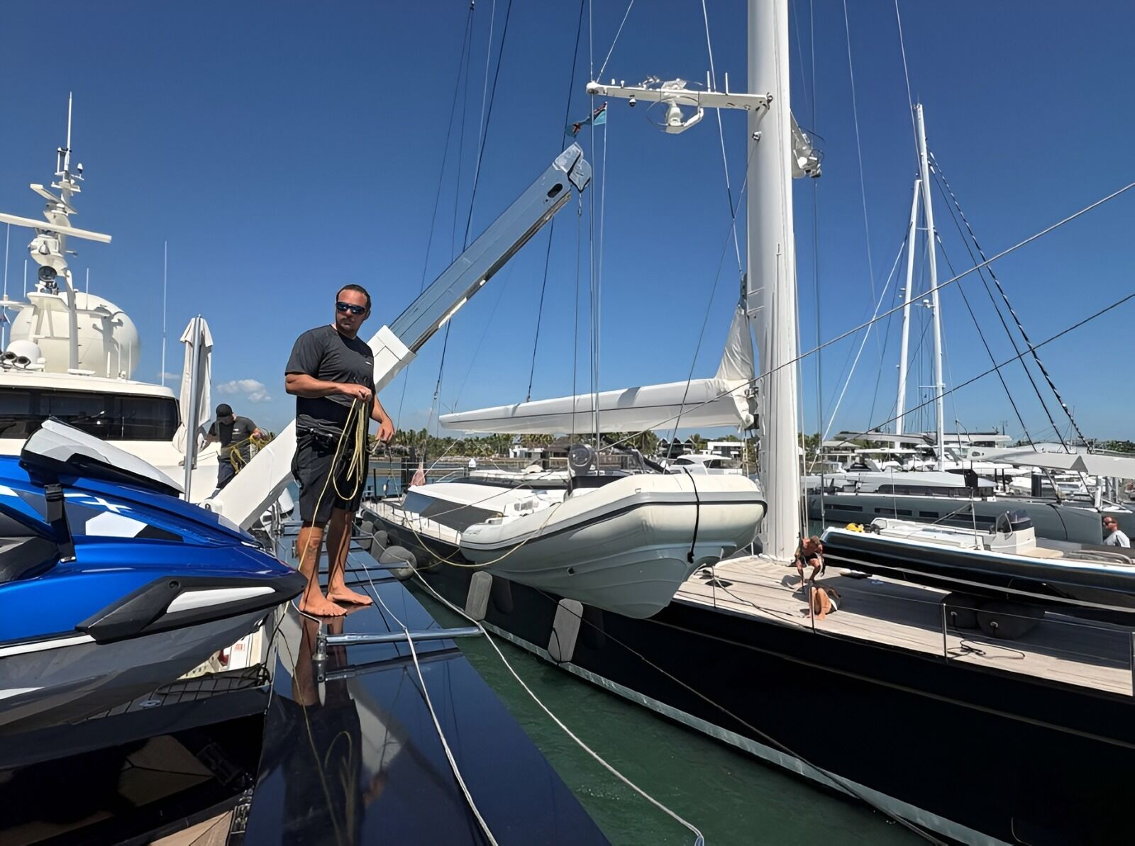 A technician on the pontoon with the rescue boat and its davit